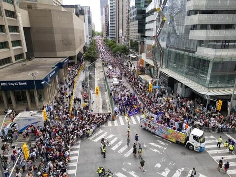 Pride Parade Crossing Intersection with Crowd in Downtown Toronto Stock Photos
