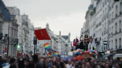 Pride parade float moving through a crowded city street Video stock 346990234