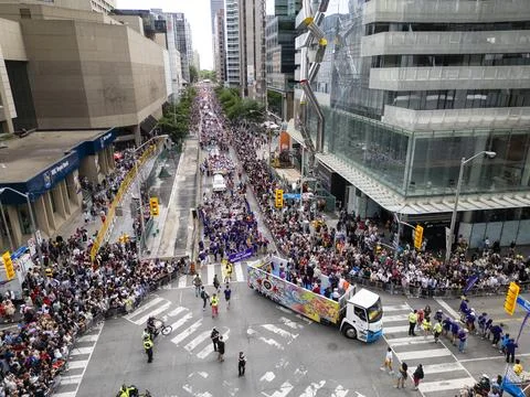 Pride Parade Float Surrounded by Large Crowd at Toronto Intersection Stock Photos