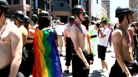 Pride parade participates topless young men with black helmet Stock Footage 7732996