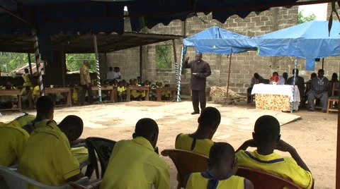 PRIEST ADDRESSING STUDENTS AT SCHOOL ASSEMBLY Stock Footage 60115419