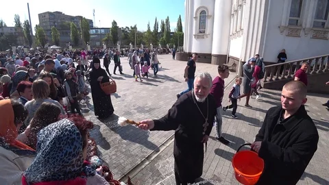 Priest Blesses Easter Cakes And Eggs by Holy Water. Stock Footage 107099016