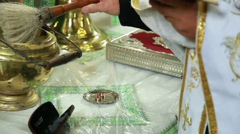 Priest blesses wedding rings lying on the table in church Stock Footage 66427904