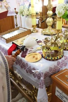 Priest blessing wedding items during an Orthodox marriage ceremony, church ta Stock Photos