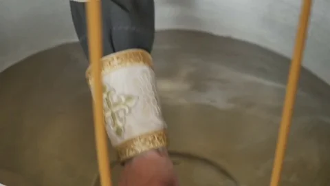 The priest crosses the water in font Video stock 78985997