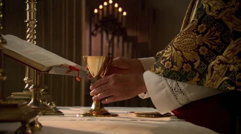 Priest elevating the chalice of wine during Eucharist Stock Footage 59250101