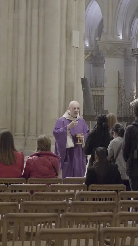 Priest Engages with Visitors Inside Iconic Notre Dame Cathedral Stock Footage 318589825