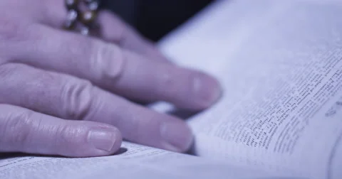 Priest hands on a bible. Stock Footage 55013702