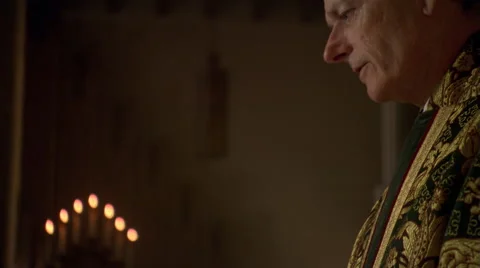 Priest making the sign of the cross with the wafer during Eucharist Stock Footage 59249932