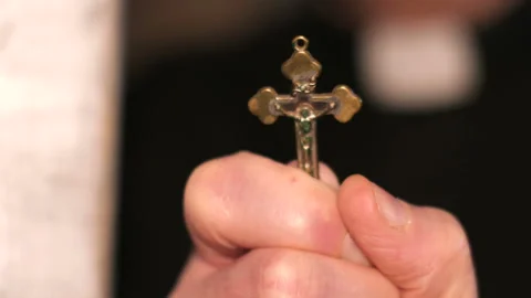 Priest Performs Exorcism with Cross Video stock 236881764