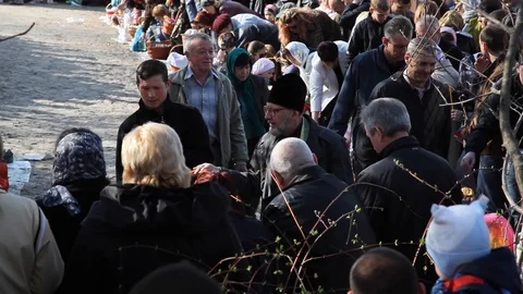 The priest pours holy water over the heads of people.  celebrate holy easter. Stock Footage 123710170