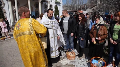 The priest pours holy water over the heads of people. celebrate holy easter. Stock Footage 123711092