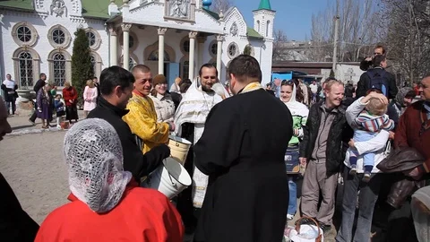The priest pours holy water over the heads of people.  celebrate holy easter. Stock Footage 123713863