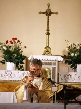 Priest, praying to God consecration the bread and wine Stock Photos