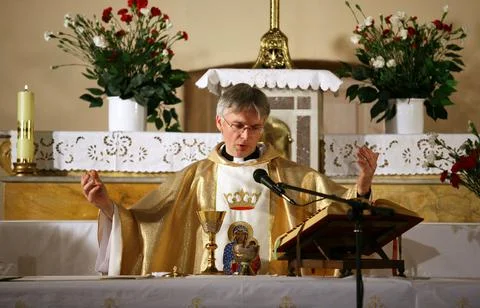 Priest, praying to God consecration the bread and wine Stock Photos