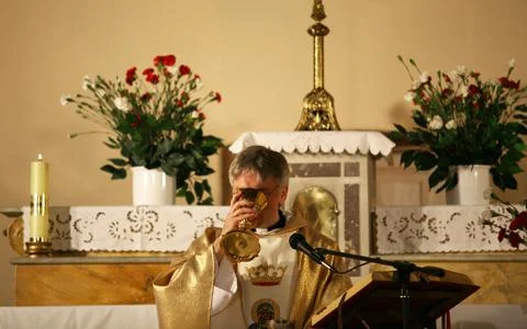 Priest, praying to God consecration the bread and wine Stock Photos
