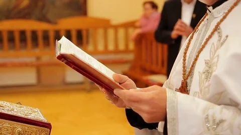 The priest read a prayer from the book Видео 75007135
