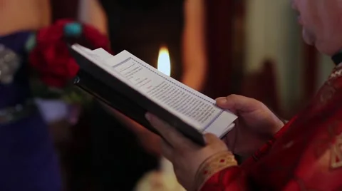 Priest read from the Scriptures during a religious weddings held in the small  스톡 동영상 60055704
