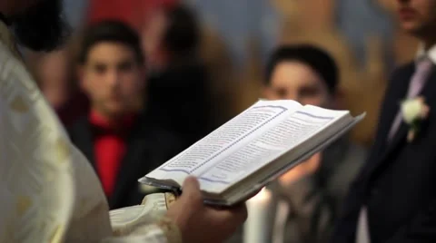 Priest read from the Scriptures during a religious weddings held in the small  Stock Footage 60055736