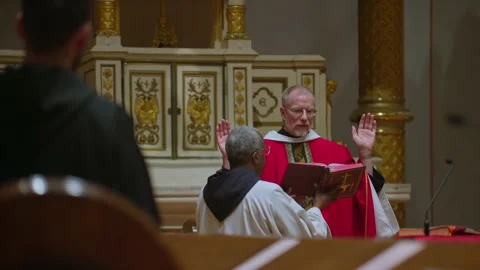 Priest reading from the bible during Sunday mass in the church. Religious Stock Footage 231293149