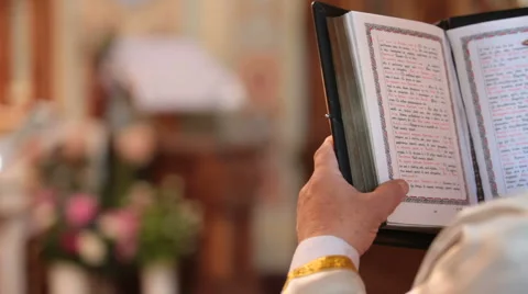 Priest reading Bible Stock Footage