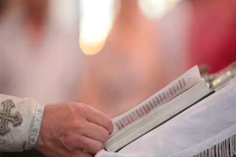 Priest reading Bible Stock Footage