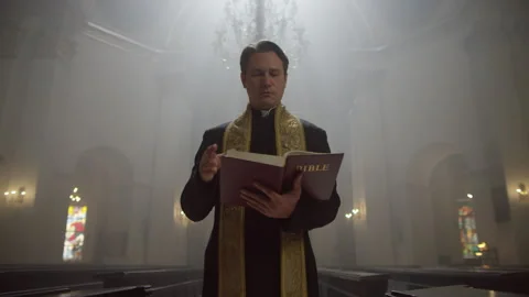 A priest reading from the Bible Stock Footage 283240463