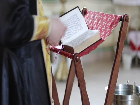 The priest reads the Bible or the prayer book. Stock Footage 80369161
