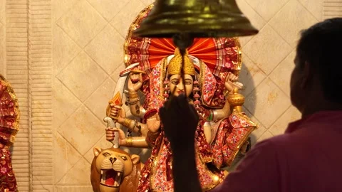 Priest Ringing Temple Bell in Front of Goddess Durga Idol Stock Footage 316895032