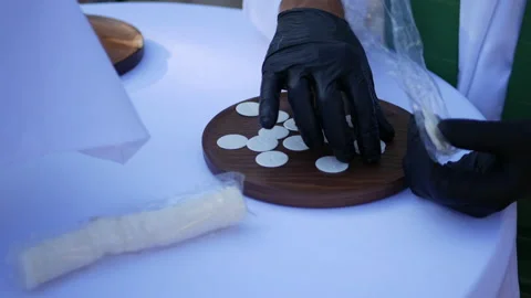 Priest in Rubber Gloves Sets out Communion Wafers Video stock 137927232
