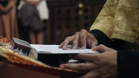 The priest stands in front of the Bible in the temple and reads a prayer Stock Footage 295890763