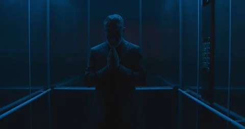 Priest stuck in an elevator asks for divine help Stock Footage 307324198