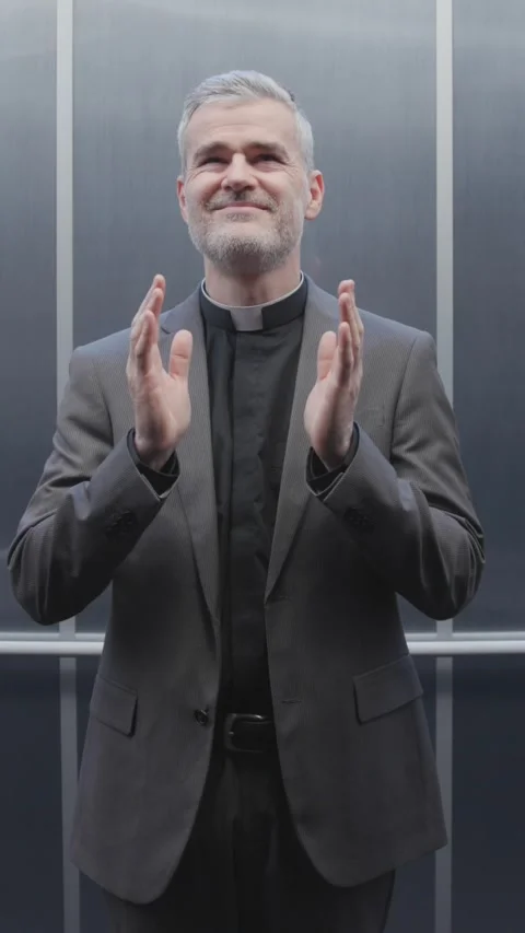 Priest stuck in an elevator asks for divine help 库存影片 307324901