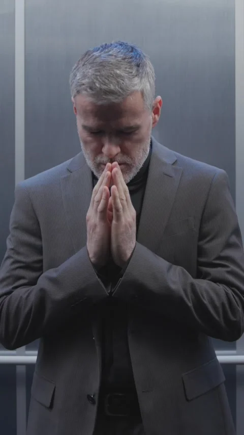 Priest stuck in an elevator asks for divine help Stock Footage 307325038