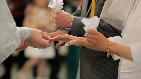 The priest wears rings to the bride and groom in the Church Stock Footage 102166345