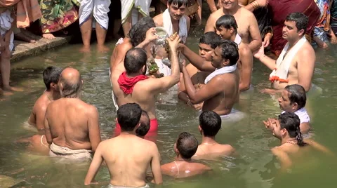 The priests do the ritual ablution of Divinity Hanuman in the kunda Stock Footage 68453846