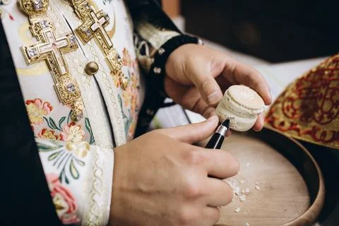 Priest's hands and bread and prayer Stock Photos