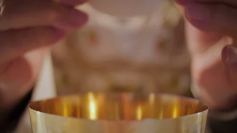 Priest's hands breaking the wafer Stock Footage 76559740