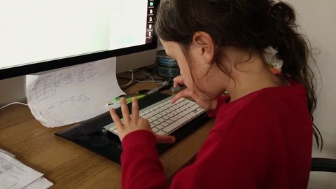 Primary school aged child researching homework using a modern computer Stock Footage 80661168