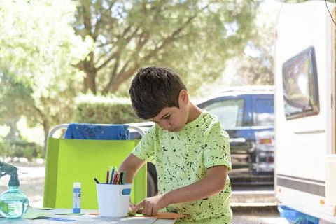 Primary school boy doing manual work while on vacation and preparing to go back Stock Photos