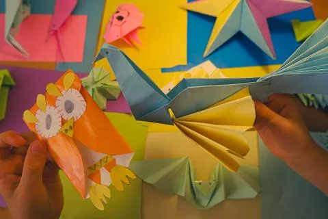 Primary school boy playing with origami that he made himself Stock Photos
