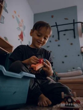 Primary school boy playing with plastic construction Stock Photos