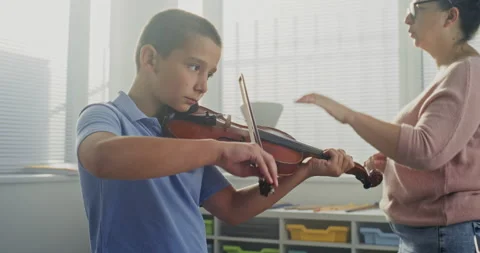 Primary School Boy Practicing Violin in Music Class, Dreaming to Become Musician Stock Footage 317547401