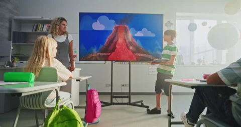 Primary School Boy Showcasing Knowledge of Geology in Front of Class and Teacher Stock Footage 315537545