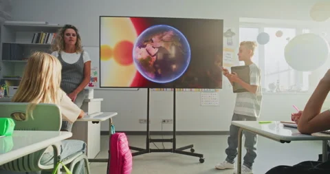 Primary School Boy Showcasing Knowledge of Astronomy in Front of Class and Stock Footage 315538496