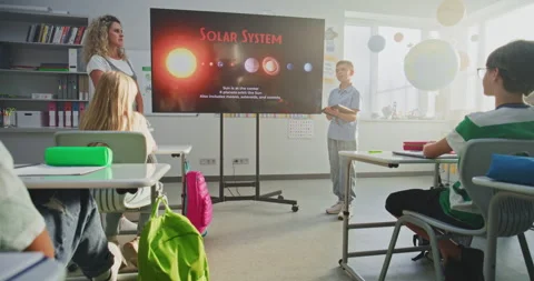 Primary School Boy Showcasing Knowledge of Astronomy in Front of Class and Stock Footage 315539451