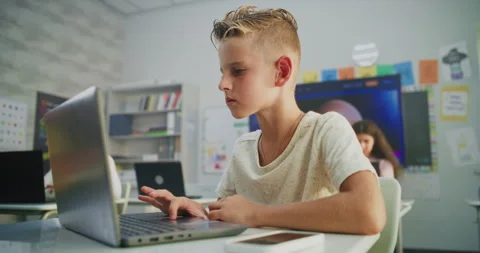 Primary School Boy Working on Creative Project on Laptop, Practicing Digital Stock Footage 315471632