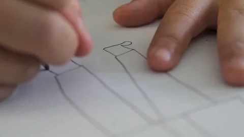Primary school child drawing a persons legs Stock Footage 75191936