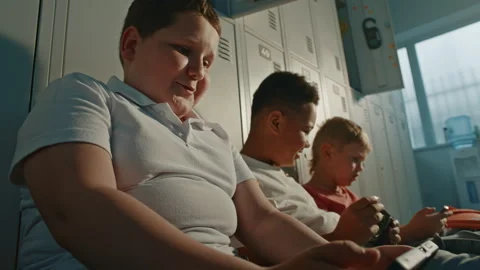 Primary School Classmates Sitting on Floor Beside Personal Lockers with Handheld Stock Footage 342020192