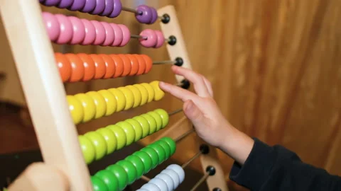Primary school girl learning math using wood abacus at home,kids son education Stock Footage 148398152